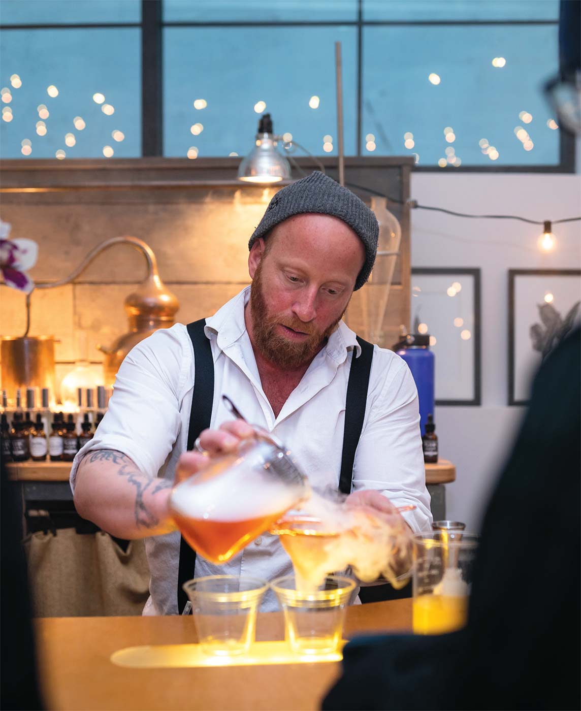 Aaron Wisniewski, owner of Alice & the Magician, concocts a tantalizing beverage aromatic.