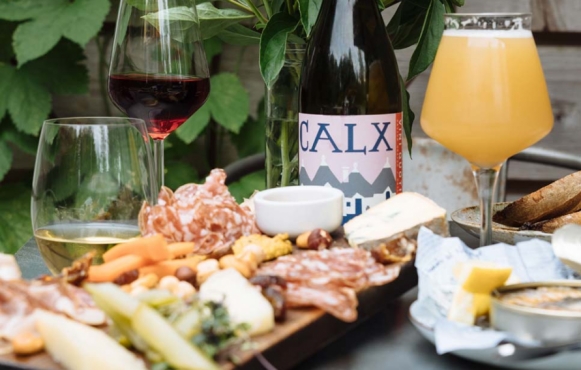 The Crooked Ram's signature cheese and charcuterie board paired with freshly poured craft beer and natural wines