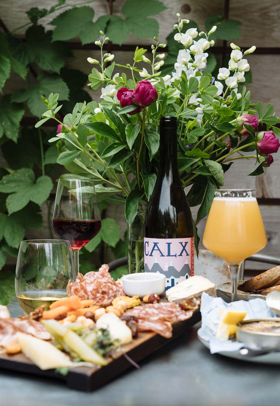 The Crooked Ram's signature cheese and charcuterie board paired with freshly poured craft beer and natural wines